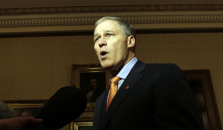Washington Gov. Jay Inslee talks to reporters following a federal appeals court's refusal to reinstate President Donald Trump's travel ban on Thursday, Feb. 9, 2017, in Olympia, Wash. Inslee called the decision a victory for both the state and the nation. (AP Photo/Rachel La Corte)
