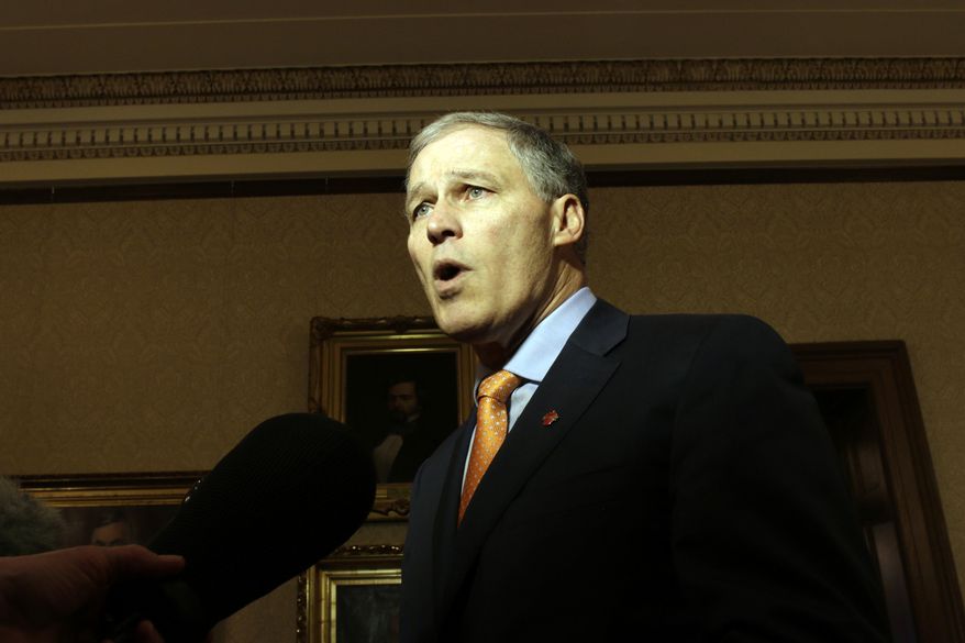 Washington Gov. Jay Inslee talks to reporters following a federal appeals court's refusal to reinstate President Donald Trump's travel ban on Thursday, Feb. 9, 2017, in Olympia, Wash. Inslee called the decision a victory for both the state and the nation. (AP Photo/Rachel La Corte)