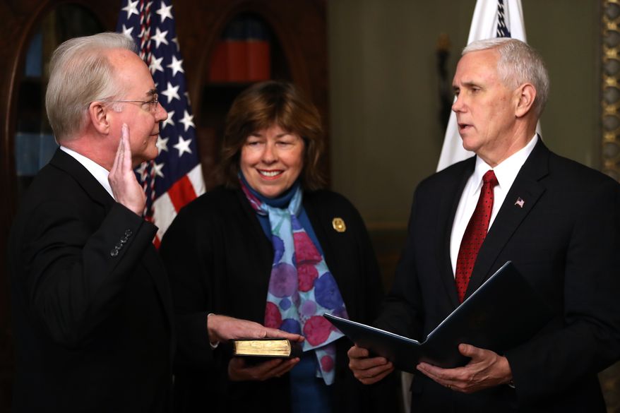 Vice President Mike Pence administers the oath of office to Health and Human Services Secretary Tom Price, accompanied by his wife Betty, Friday, Feb. 10, 2017,  in the in the Eisenhower Executive Office Building on the White House complex in Washington. (AP Photo/Andrew Harnik)