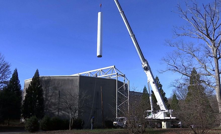 A crane lifts a section of the panoramic painting depicting the Battle of Atlanta from the American Civil War through the roof at Grant Park in Atlanta, Friday, Feb. 10, 2017. Historians hailed the delicate, painstaking move as a milestone for the 6-ton Cyclorama — one of the world's largest paintings — which was being moved in two sections from the city's Grant Park to the Atlanta History Center. (AP Photo/Alex Sanz)