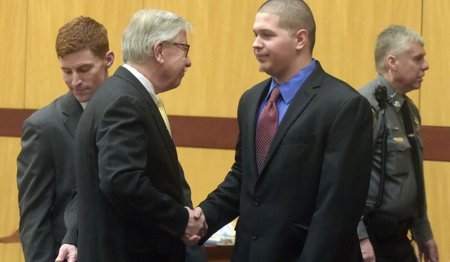 Defendant Tony Moreno, center right, shakes hands with Frederick O'Brien, one of his defense attorneys, after walking into a courtroom at Middletown Superior Court, Friday, Feb. 10, 2017, in Middletown, Conn. Moreno is charged with killing his 7-month-old son by throwing the boy off a bridge. (Patrick Raycraft/Hartford Courant via AP, Pool)