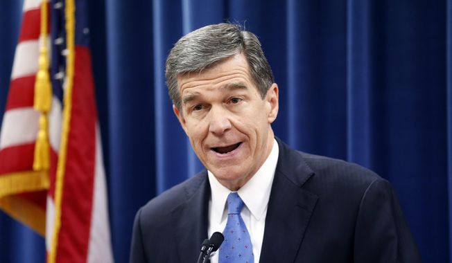 FILE - In this Dec. 15, 2016 file photo, North Carolina&#x27;s Governor-elect Roy Cooper holds a news conference to criticize efforts by Republicans to cut the power of the governor&#x27;s office during the special session of the General Assembly that is going on a few blocks away in Raleigh, N.C.   Republican efforts to reduce Cooper&#x27;s authority in choosing his Cabinet are back in court. A three-judge panel scheduled arguments Friday, Feb. 10, 2017,  on whether to extend their recent temporary block of a law requiring Senate confirmation of Cooper&#x27;s Cabinet secretaries.(Chris Seward /The News &amp;amp; Observer via AP, File)