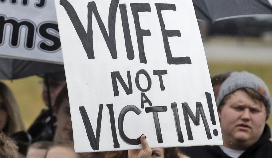 Pro-polygamy protesters holds signs during a rally at the state Capitol Friday, Feb. 10, 2017, in Salt Lake City. Several hundred people in polygamist relationships say they want Utah lawmakers and law enforcement officials to know that they're not going away and should be allowed the freedom to practice their plural marriages. (AP Photo/Rick Bowmer)