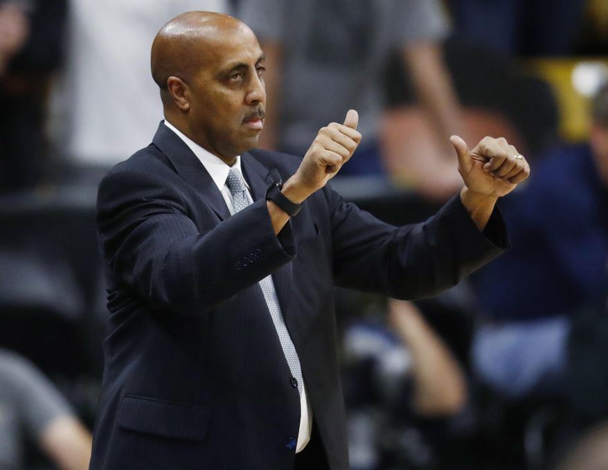 Washington head coach Lorenzo Romar signals to his players as they face Colorado in the first half of an NCAA college basketball game Thursday, Feb. 9, 2017, in Boulder, Colo. (AP Photo/David Zalubowski)