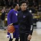 Washington guard Markelle Fultz dribbles a ball as his teammates warm up for an NCAA college basketball game against Colorado on Thursday, Feb. 9, 2017, in Boulder, Colo. Fultz, projected as a top pick in this year&#x27;s NBA draft, is sitting out the game because of a sore knee. (AP Photo/David Zalubowski)