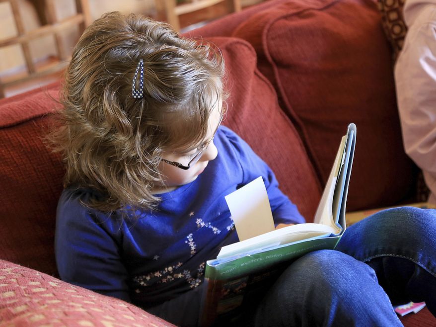ADVANCE FOR THE WEEKEND OF FEB 11-12 AND THEREAFTER - In a Jan. 27, 2017 photo, Olivia MacKay, 9, reads a book at her home in St. George, Utah. She says her tutor has helped her overcome some of the challenges of dyslexia. (Brian Passey/The Spectrum & Daily News via AP)