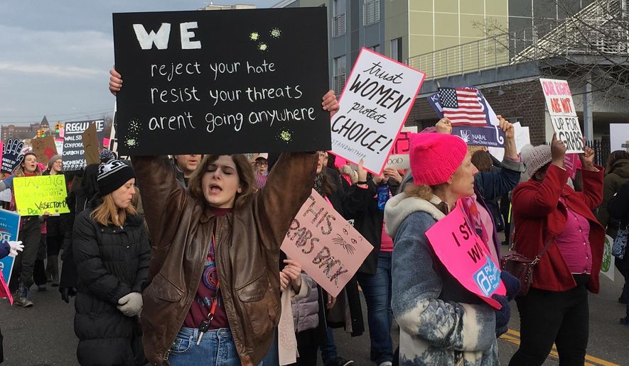 People march in support of Planned Parenthood in Detroit on Saturday, Feb. 11, 2017. . The event drew more than 300 people. (AP Photo/Ed White)
