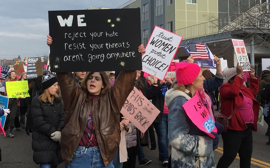People march in support of Planned Parenthood in Detroit on Saturday, Feb. 11, 2017. . The event drew more than 300 people. (AP Photo/Ed White)