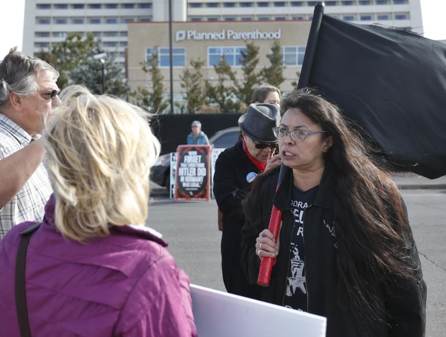 Pro-choice demonstrator Brenda Zee, right, confronts anti-abortion activist Susan Sutherland, of Colorado Right to Life, during a rally in front of Planned Parenthood of the Rocky Mountains, in Denver, Saturday, Feb. 11, 2017. Anti-abortion activists emboldened by the new administration of President Donald Trump staged rallies around the country Saturday calling for the federal government to cut off payments to Planned Parenthood. (AP Photo/Brennan Linsley)
