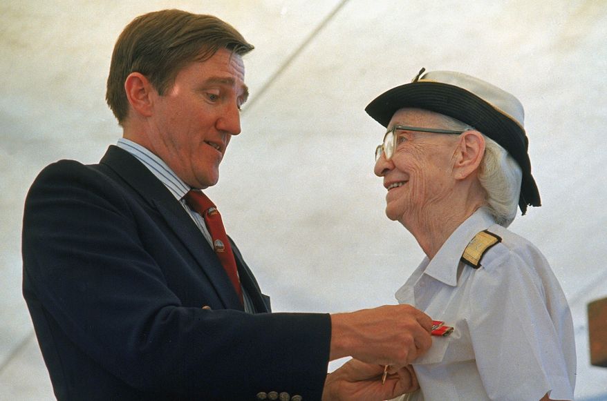 FILE - In this Aug. 14, 1986 file photo, Admiral Grace Hopper is honored by Navy Secretary John Lehman, during her retirement ceremony aboard the USS Constitution, in Boston, Mass. On Saturday, Feb. 11, 2017, Yale University said it is renaming Calhoun College after Hooper, a trailblazing computer scientist, a mathematician who earned Yale degrees in the 1930s, invented a pioneering computer programming language and became a Navy rear admiral. (AP Photo/Peter Southwick)