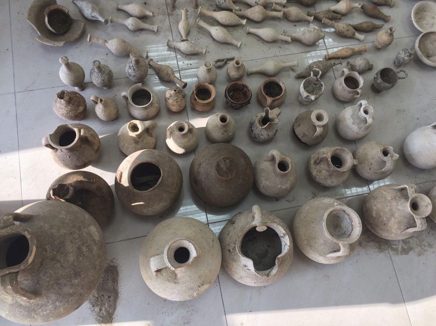 In this undated photo provided by the Albanian Police on Sunday, Feb. 12, 2017, Archaeological artifacts from ancient Apollonia on display, in Radostine, Albania. Albanian police say they have prevented the smuggling of 230 archaeological artifacts from ancient Apollonia and have arrested two people adding that the artifacts were found at the arrested men's houses in Radostine, a village 120 kilometers (75 miles) south of the capital, Tirana. (Albania Police via AP)