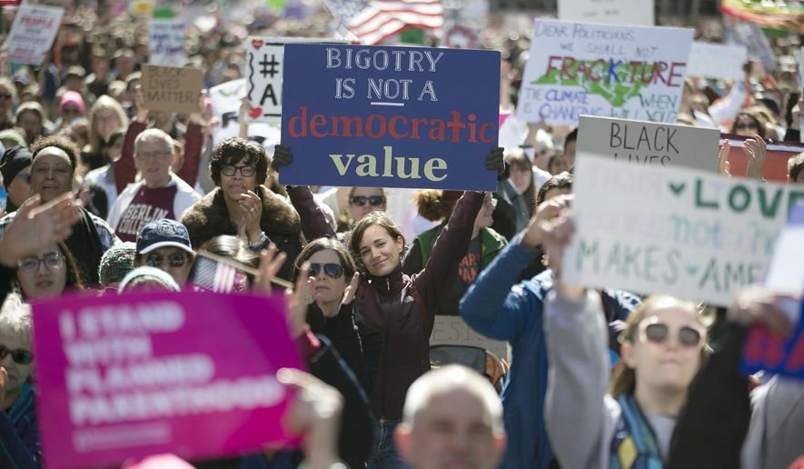 Thousands pack Fayetteville Street to listen as Rev. William Barber addresses the crowd during the annual “Historic Thousands on Jones Street" (HKonJ) march in Raleigh, N.C., on Saturday, Feb. 11, 2017. The rally was organized to express support for the Affordable Care Act, opposition to President Donald Trump’s plans to build a wall along the border with Mexico and his executive order on immigration. (Robert Willett/The News & Observer via AP)