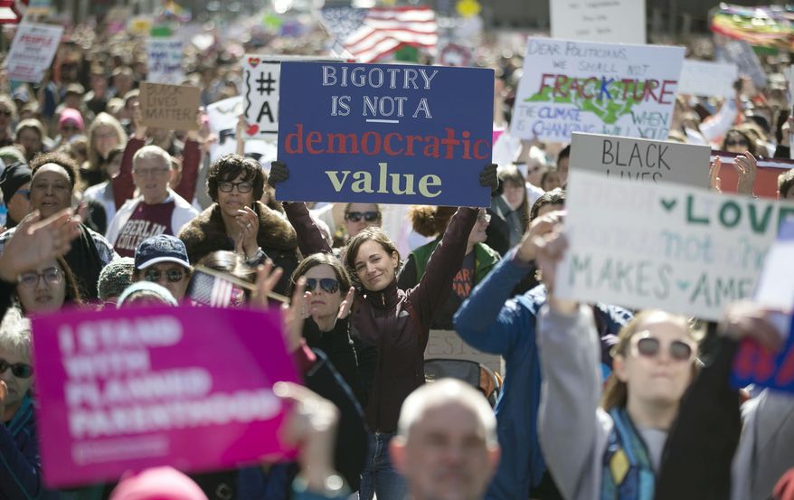 Thousands pack Fayetteville Street to listen as Rev. William Barber addresses the crowd during the annual “Historic Thousands on Jones Street" (HKonJ) march in Raleigh, N.C., on Saturday, Feb. 11, 2017. The rally was organized to express support for the Affordable Care Act, opposition to President Donald Trump’s plans to build a wall along the border with Mexico and his executive order on immigration. (Robert Willett/The News & Observer via AP)