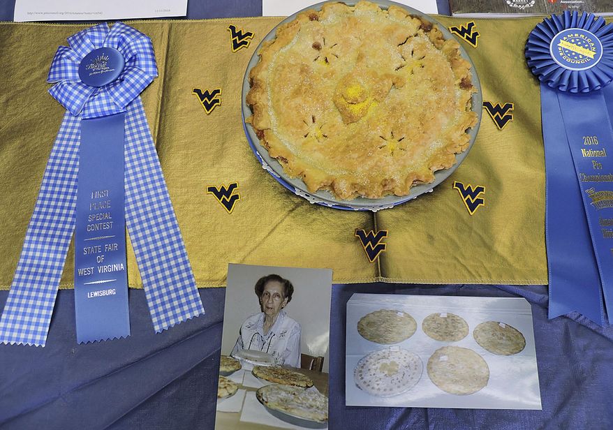 In this undated photo, a display in Fairmont, W.Va., of Carolyn Blakemore's first-place ribbons from the West Virginia State Fair and the National Pie Championship that was presented to her for best apple pie is viewed. There is nothing more American than apple pie, and Blakemore has been known to make the best apple pie for years. (Sarah Goodrich/Times West Virginian, via AP)