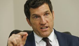 In this Friday, Oct. 7, 2016, photo, Virginia&#39;s 2nd District Congressman Scott Taylor speaks during an interview in his campaign office in Virginia Beach, Va. Mr. Taylor is among a cadre of former Navy SEALs who’ve recently ascended to major elected office. (AP Photo/Steve Helber)
