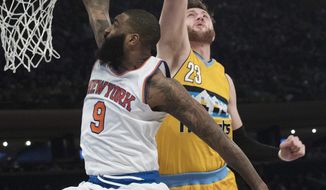 New York Knicks center Kyle O&#x27;Quinn (9) scores a goal past Denver Nuggets center Jusuf Nurkic (23) during the second half of an NBA basketball game, Friday, Feb. 10, 2017, at Madison Square Garden in New York. The Nuggets won 131-123. (AP Photo/Mary Altaffer)