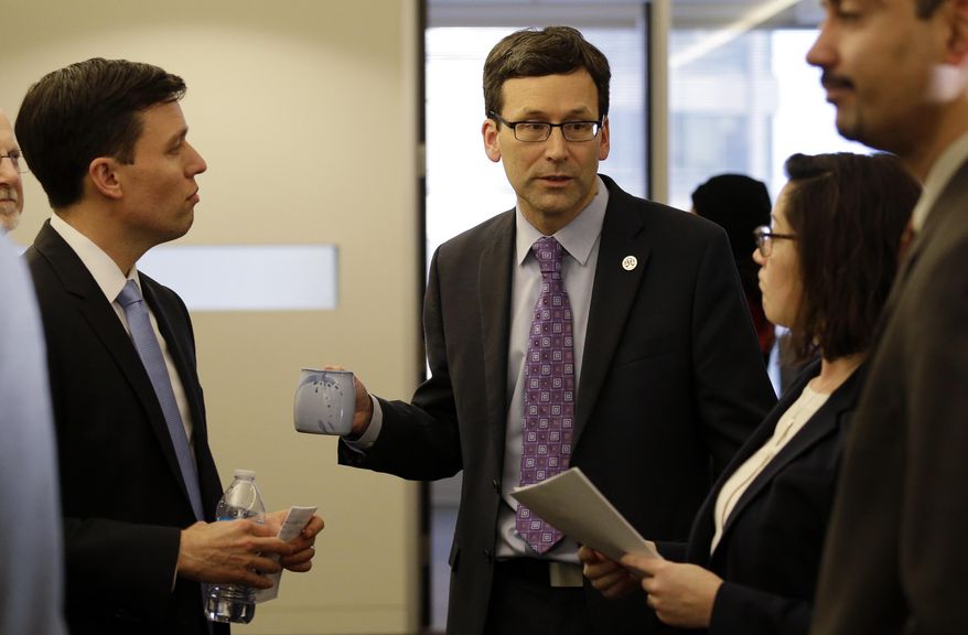 Washington Attorney General Bob Ferguson, center, speaks with Solicitor General Noah Purcell, left, and Civil Rights Unit Chief Colleen Melody in a hallway before a news conference about a federal appeals court's refusal to reinstate President Donald Trump's ban on travelers from seven predominantly Muslim nations, Thursday, Feb. 9, 2017, in Seattle. The ruling dealt another legal setback to the new administration's immigration policy. In a unanimous decision, the panel of three judges from the San Francisco-based 9th U.S. Circuit Court of Appeals declined to block a lower-court ruling that suspended the ban and allowed previously barred travelers to enter the U.S. An appeal to the U.S. Supreme Court is possible. (AP Photo/Elaine Thompson)