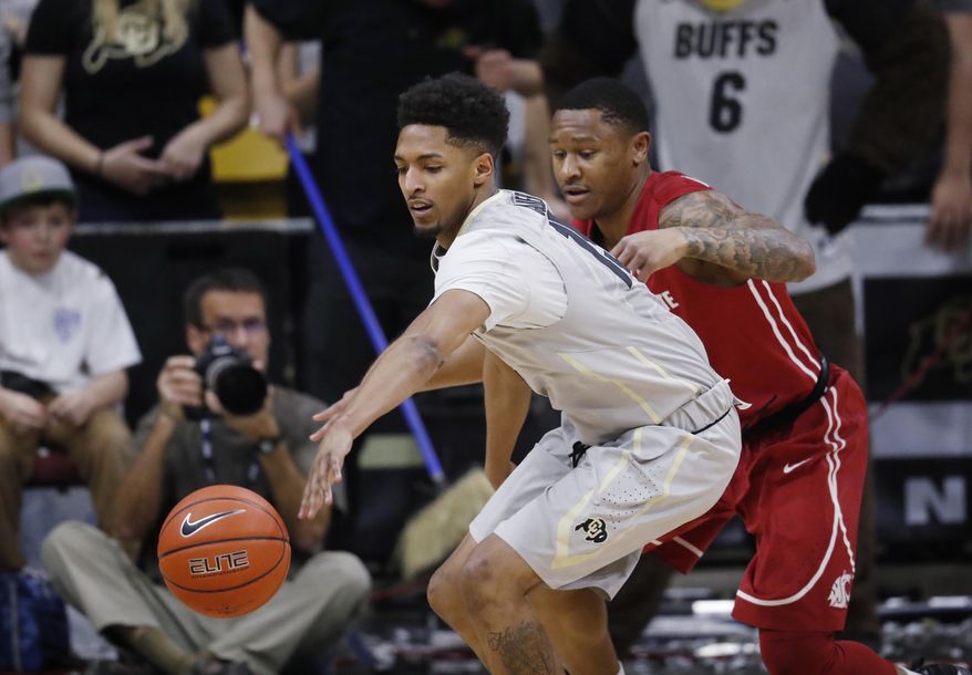 Colorado guard Dominique Collier, front, reaches out for a loose ball as Washington State guard Charles Callison defends in the first half of an NCAA college basketball game, Sunday, Feb. 12, 2017, in Boulder, Colo. (AP Photo/David Zalubowski)