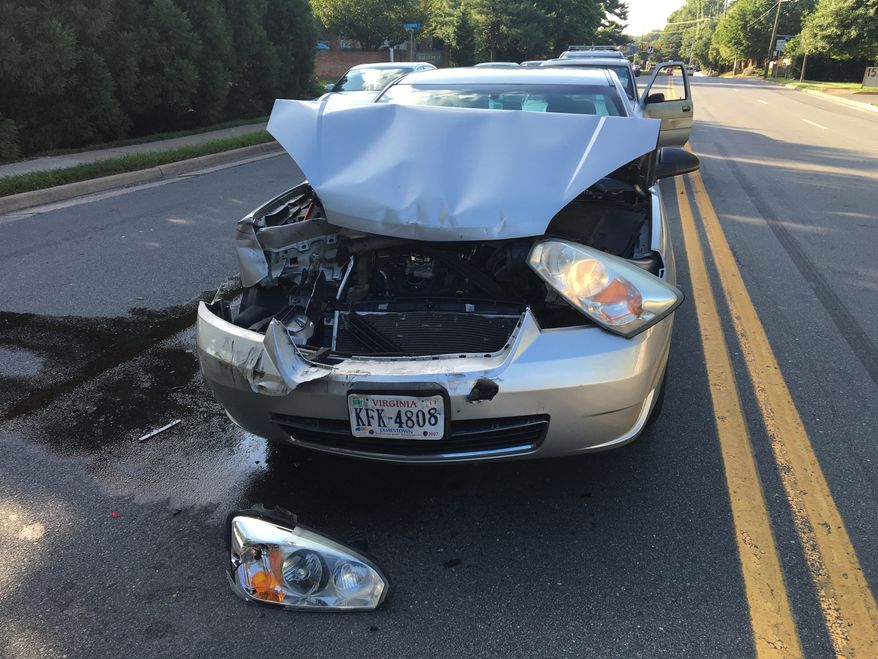 In this photo taken Feb. 9, 2016, a car involved in an accident sits in the road Virginia. The Consumer Federation of America says it found premium hikes in some cases reaching $400. It looked at premium quotes in 10 cities from five of the nations largest auto insurers and found that Progressive aggressively used a not-at-fault penalty, surcharging drivers in eight of the ten cities. (AP Photo/Jennifer C. Kerr)