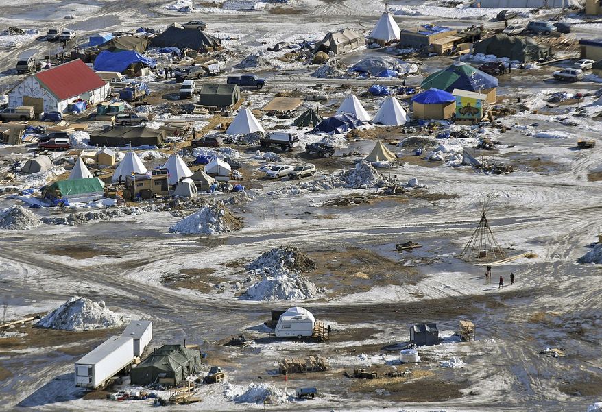 This aerial photo shows the Oceti Sakowin camp, where people have gathered to protest the Dakota Access pipeline on federal land, Monday, Feb. 13, 2017, in Cannon Ball, N.D. A federal judge on Monday refused to stop construction on the last stretch of the Dakota Access pipeline, which is progressing much faster than expected. (Tom Stromme/The Bismarck Tribune via AP)