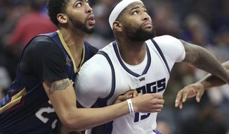 Sacramento Kings center DeMarcus Cousins (15) and New Orleans Pelicans center Anthony Davis (23) battle for position under the basket during the second half of an NBA basketball game in Sacramento, Calif., Sunday, Feb. 12, 2017. The Kings won 105-99. (AP Photo/Steve Yeater)