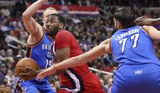 Washington Wizards guard John Wall, center, drives to the basket against Oklahoma City Thunder forward Kyle Singler, left, and center Joffrey Lauvergne (77), of France, during the second half of an NBA basketball game, Monday, Feb. 13, 2017, in Washington. The Wizards won 120-98. (AP Photo/Nick Wass)