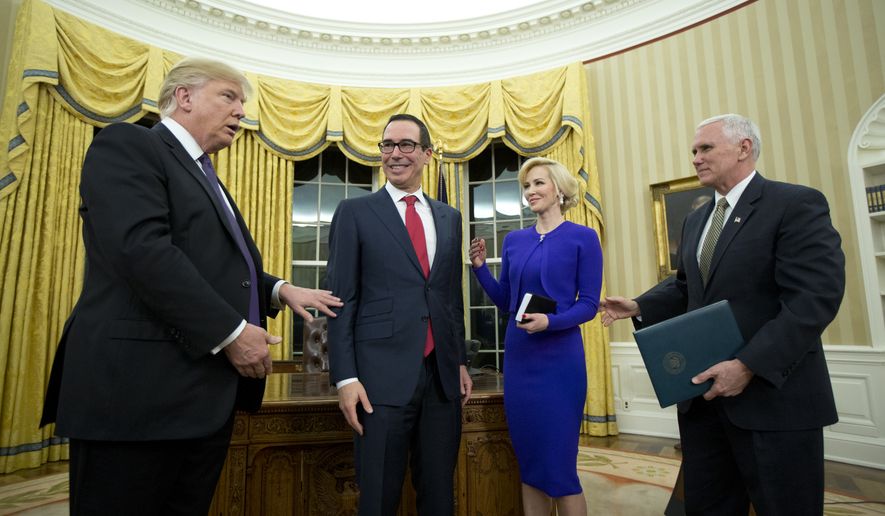 President Donald Trump and Vice President Mike Pence lead Treasury Secretary Steven Mnuchin with his fiancée Scottish actress Louise Linton, to a table to sign documents in the Oval Office of the White House in Washington, Monday, Feb. 13, 2017.  (AP Photo/Manuel Balce Ceneta)