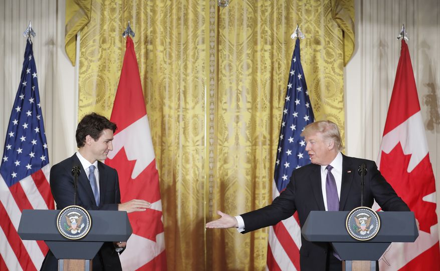 President Donald Trump extends his hand to Canadian Prime Minister Justin Trudeau during a joint news conference in the East Room of the White House in Washington, Monday, Feb. 13, 2017. (AP Photo/Pablo Martinez Monsivais)