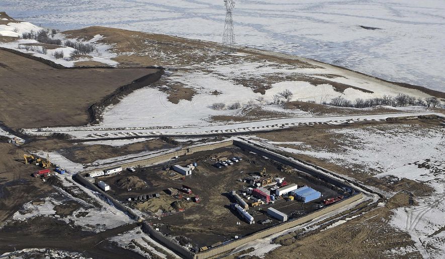 This aerial photo shows a site where the final phase of the Dakota Access Pipeline will take place with boring equipment routing the pipeline underground and across Lake Oahe to connect with the existing pipeline in Emmons County, Monday, Feb. 13, 2017, in Cannon Ball, N.D. It is the last big section of the $3.8 billion pipeline, which would carry oil from North Dakota to Illinois. A federal judge on Monday refused to stop construction on the last stretch of the pipeline, which is progressing much faster than expected. (Tom Stromme/The Bismarck Tribune via AP)