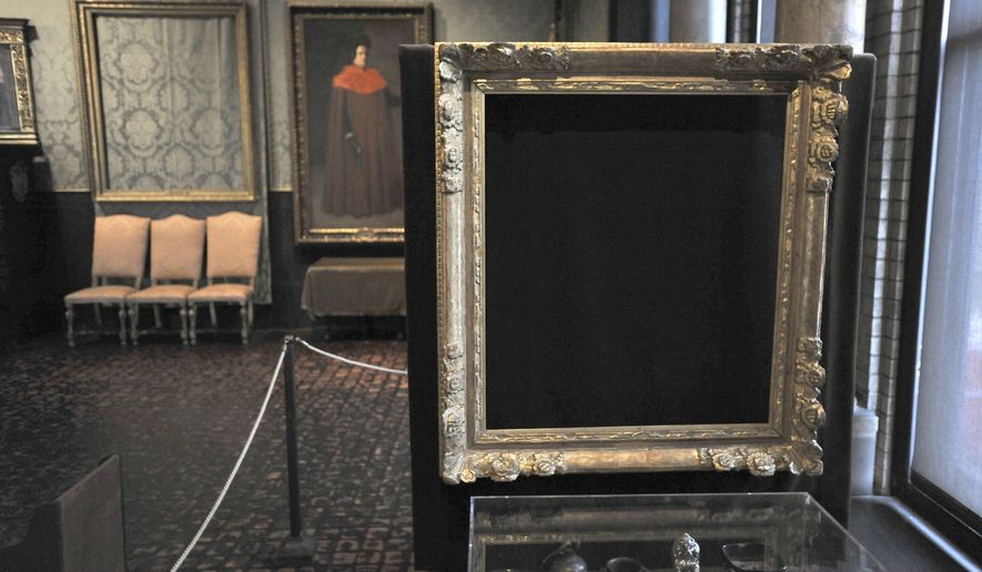 FILE - In this March 11, 2010, file photo, empty frames from which thieves took "Storm on the Sea of Galilee," left background, by Rembrandt and "The Concert," right foreground, by Vermeer, remain on display at the Isabella Stewart Gardner Museum in Boston. The Mead Art Museum in Amherst, Mass., is offering visitors a unique glimpse of the 13 masterpieces stolen more than a quarter century ago from the Gardner Museum. The exhibit opening Tuesday, Feb. 14, 2017, shows the work of San Francisco-based artist Kota Ezawa. (AP Photo/Josh Reynolds, File)