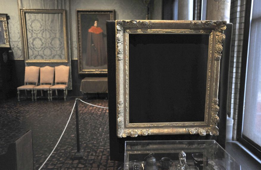FILE - In this March 11, 2010, file photo, empty frames from which thieves took "Storm on the Sea of Galilee," left background, by Rembrandt and "The Concert," right foreground, by Vermeer, remain on display at the Isabella Stewart Gardner Museum in Boston. The Mead Art Museum in Amherst, Mass., is offering visitors a unique glimpse of the 13 masterpieces stolen more than a quarter century ago from the Gardner Museum. The exhibit opening Tuesday, Feb. 14, 2017, shows the work of San Francisco-based artist Kota Ezawa. (AP Photo/Josh Reynolds, File)