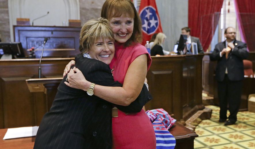 FILE - In an April 17, 2014, file photo, Rep. Terri Lynn Weaver, left, R-Lancaster, hugs House Speaker Beth Harwell, R-Nashville, right, on the final day of the 108th General Assembly in Nashville, Tenn. Gay rights advocates are raising the alarm about a Tennessee bill sponsored by Weaver they say could make it impossible for same-sex couples to be recognized as the legal parents of children. The bill would repeal a 1977 state law that declared children born as a result of artificial insemination to be the legitimate offspring of the husband and wife. (AP Photo/Mark Humphrey, File)