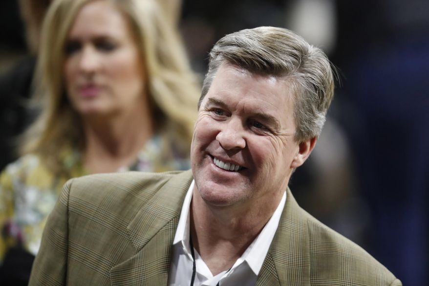 This Jan. 28, 2017 file photo shows Colorado head football coach Mike MacIntyre smiling as he makes his way through the crowd to watch Oregon play Colorado in an NCAA college basketball game in Boulder, Colo. MacIntyre's $16.25 million contract extension is being held up as the University of Colorado looks into his handling of domestic abuse allegations levied against a former assistant coach. (AP Photo/David Zalubowski)