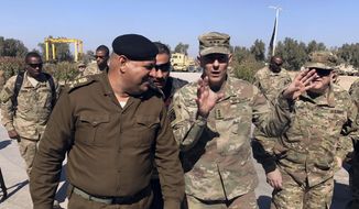 In this Wednesday, Feb. 8, 2017, file photo, U.S. Army Lt. Gen. Stephen Townsend talks with an Iraqi officer during a tour north of Baghdad, Iraq. (AP Photo/Ali Abdul Hassan, File)