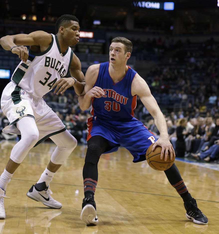Detroit Pistons' Jon Leuer (30) drives against the Milwaukee Bucks' Giannis Antetokounmpo (34) during the first half of an NBA basketball game Monday, Feb. 13, 2017, in Milwaukee. (AP Photo/Jeffrey Phelps)