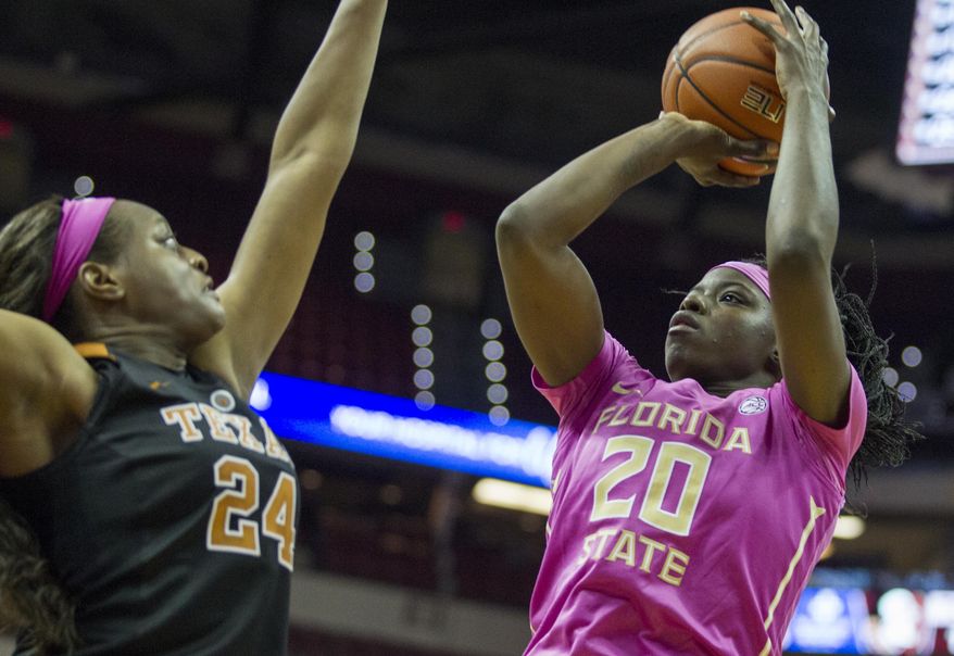 Florida State forward Shakayla Thomas shoots over Texas forward Joyner Holmes in the second half of an NCAA college basketball game in Tallahassee, Fla., Monday, Feb. 13, 2017. Texas defeated Florida State 88-92 in double overtime. (AP Photo/Mark Wallheiser)