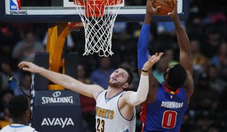 FILE - In this Nov. 12, 2016, file photo, Detroit Pistons center Andre Drummond, right, goes up for a basket over Denver Nuggets center Jusuf Nurkic, of Bosnia Herzegovina, in the second half of an NBA basketball game in Denver. A person with knowledge of the situation tells The Associated Press that the Denver Nuggets have traded Nurkic to the Portland Trail Blazers for center Mason Plumlee on Sunday, Feb. 12, 2017. (AP Photo/David Zalubowski, file)