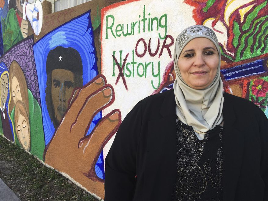 In this Wednesday, Feb, 1, 2017 photo, activist Samia Assed stands in front of a mural at the Albuquerque Center for Peace and Justice coalition in Albuquerque, N.M. Assed, a Palestinian-American, has now turned her fears over Donald Trump's election into action, joining what advocacy groups said are hundreds, possibly thousands of women of color, who are exploring making a run for public office. (AP Photo/Russell Contreras)