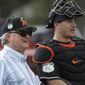 Miami Marlins owner Jeffrey Loria, right, watches with catcher J.T. Realmuto during a spring training baseball workout Tuesday, Feb. 14, 2017, in Jupiter, Fla. (AP Photo/David J. Phillip)