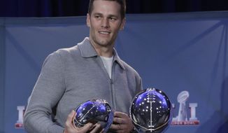 In this Feb. 6, 2017, photo, New England Patriots quarterback Tom Brady walks off with his MVP trophy during a news conference after the NFL Super Bowl 51 football game in Houston. (Associated Press) **FILE**