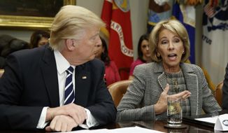 President Donald Trump listens as Secretary of Education Betsy DeVos speaks during a meeting with parents and teachers, Tuesday, Feb. 14, 2017, in the Roosevelt Room of the White House in Washington. (AP Photo/Evan Vucci) ** FILE **