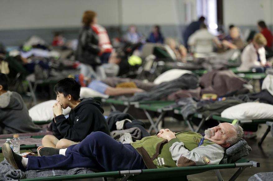 Evacuees rest at a shelter for residents of cities surrounding the Oroville Dam, Monday, Feb. 13, 2017, in Chico, Calif. The thousands of people who were ordered to leave their homes after a damaged California spillway threatened to unleash a 30-foot wall of water may not be able to return until significant erosion is repaired, authorities said Monday. (AP Photo/Marcio Jose Sanchez)