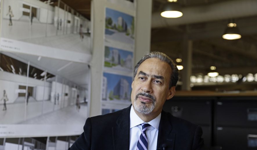 In this Wednesday, Jan. 18, 2017, photo, architect Phil Freelon responds to a question during an interview at his office in Durham, N.C. For Freelon, the National Museum of African American History and Culture was a crowning triumph, yet its opening last year came amid a wrenching personal trial. His monumental achievement came on the heels of a diagnosis of ALS, a degenerative neurological disease that eventually leads to total paralysis. (AP Photo/Gerry Broome)