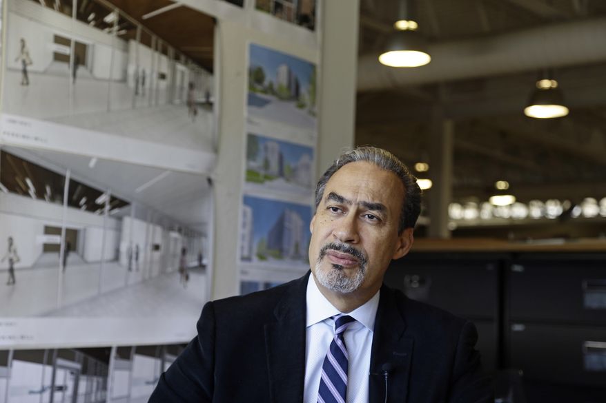 In this Wednesday, Jan. 18, 2017, photo, architect Phil Freelon responds to a question during an interview at his office in Durham, N.C. For Freelon, the National Museum of African American History and Culture was a crowning triumph, yet its opening last year came amid a wrenching personal trial. His monumental achievement came on the heels of a diagnosis of ALS, a degenerative neurological disease that eventually leads to total paralysis. (AP Photo/Gerry Broome)