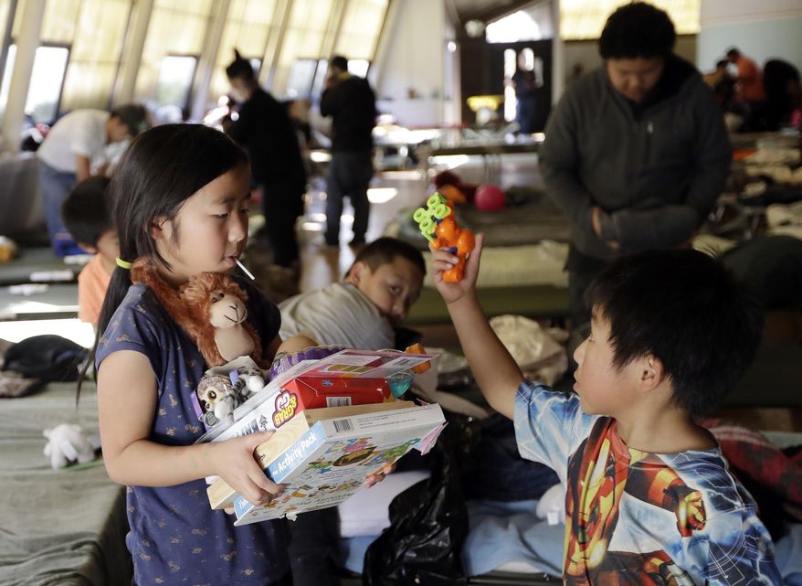 Young evacuees gather their belongings as they prepare to leave a shelter Tuesday, Feb. 14, 2017, in Chico, Calif. Authorities lifted an evacuation order Tuesday for thousands of California residents who live below the nation's tallest dam after declaring that the risk of catastrophic collapse of a damaged spillway had been significantly reduced. (AP Photo/Marcio Jose Sanchez)