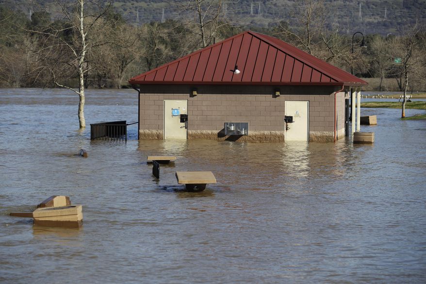 A building is submerged from the overflowing Feather River downstream from a damaged dam at Riverbend Park on Tuesday, Feb. 14, 2017, in Oroville, Calif. Workers are rushing to repair the barrier at the nation's tallest dam after authorities on Sunday ordered the evacuation for everyone living below the lake amid concerns the spillway could fail and send water roaring downstream. (AP Photo/Marcio Jose Sanchez)