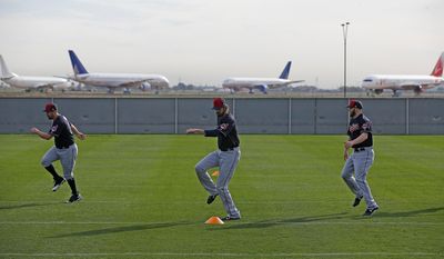 Cleveland Indians pitchers Bryan Shaw, left, Andrew Miller, center, and Cody Allen, right, warm up at the Indians baseball spring training facility Tuesday, Feb. 14, 2017, in Goodyear, Ariz. (AP Photo/Ross D. Franklin)