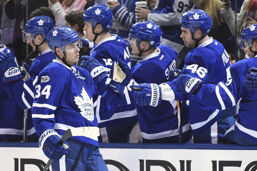 Toronto Maple Leafs centre Auston Matthews (34) celebrates with teammates after scoring a power play goal against the New York Islanders during third period NHL hockey action in Toronto on Tuesday, Feb. 14, 2017. (Frank Gunn/The Canadian Press via AP)