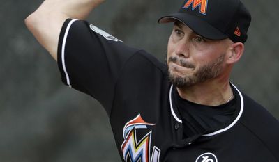Miami Marlins relief pitcher Dustin McGowan throws during a spring training baseball workout Tuesday, Feb. 14, 2017, in Jupiter, Fla. (AP Photo/David J. Phillip)