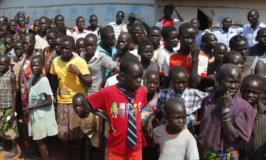 FILE - In this Monday, Aug. 29, 2016 file photo, refugees wait for U.N. High Commissioner for Refugees Filippo Grandi to arrive at a transit center for South Sudanese refugees in the remote northwestern district of Adjumani, near the border with South Sudan, in Uganda. More than 1.5 million South Sudanese have become refugees and their humanitarian needs are overwhelming aid efforts during the country's civil war, according to the United Nations. (AP Photo/Stephen Wandera, File)